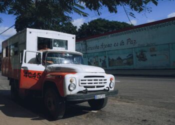 Vintage truck parked in an urban setting on a sunny summer day.