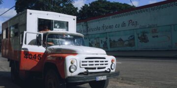 Vintage truck parked in an urban setting on a sunny summer day.