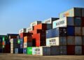 Colorful stacked shipping containers at a port exemplify global logistics.