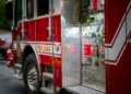 Detailed view of a fire truck's control panel parked on an urban street.