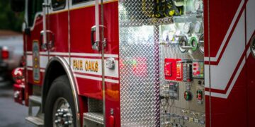 Detailed view of a fire truck's control panel parked on an urban street.